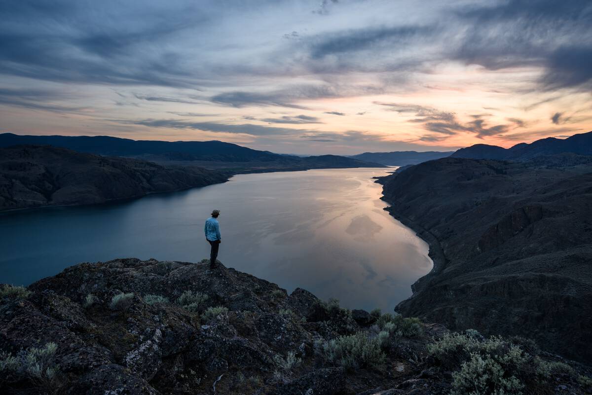 A hiker watches the sunset atop Battle Bluff