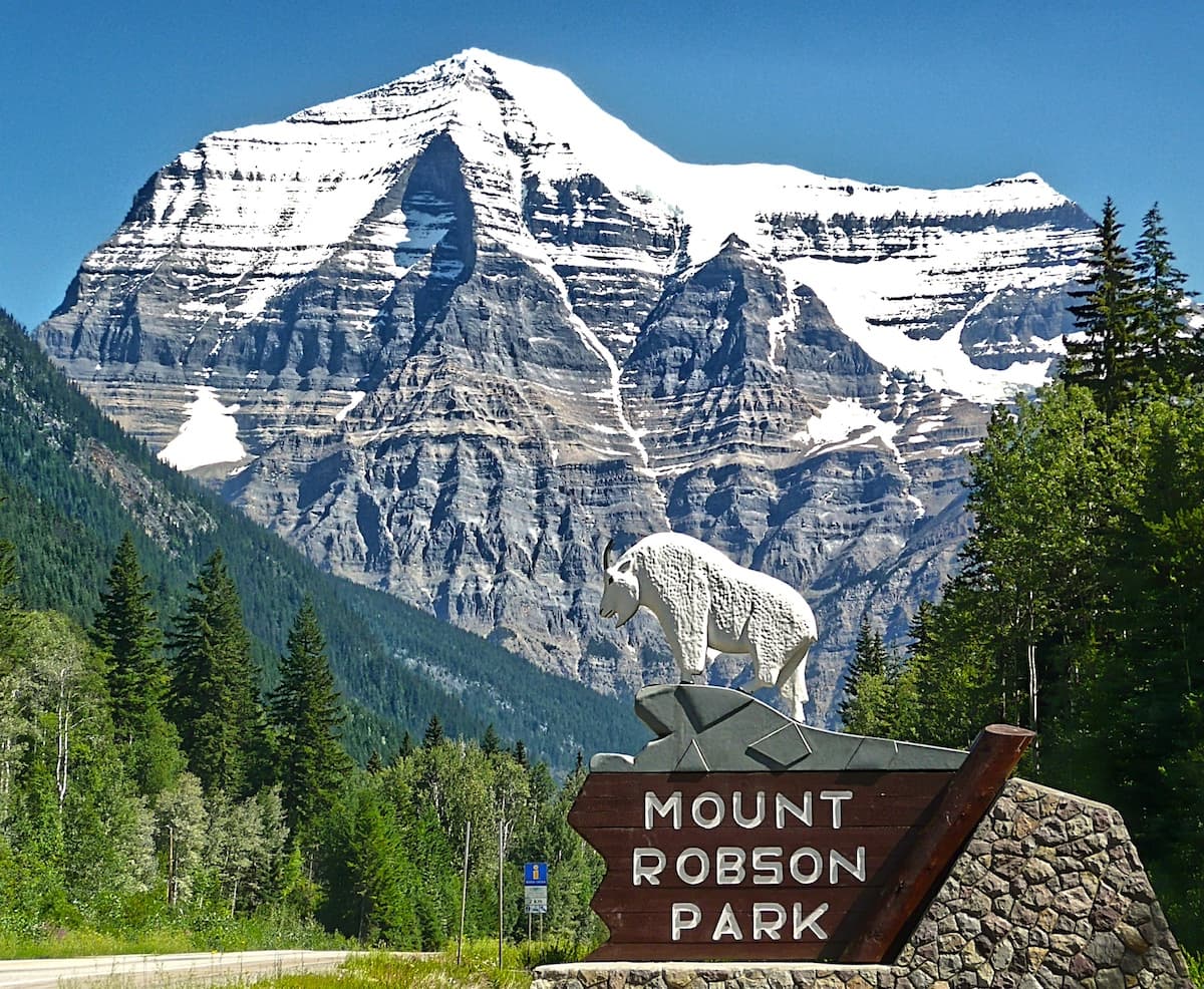 Entrance sign to Mount Robson Park in Valemount with large snow-capped mountain in background