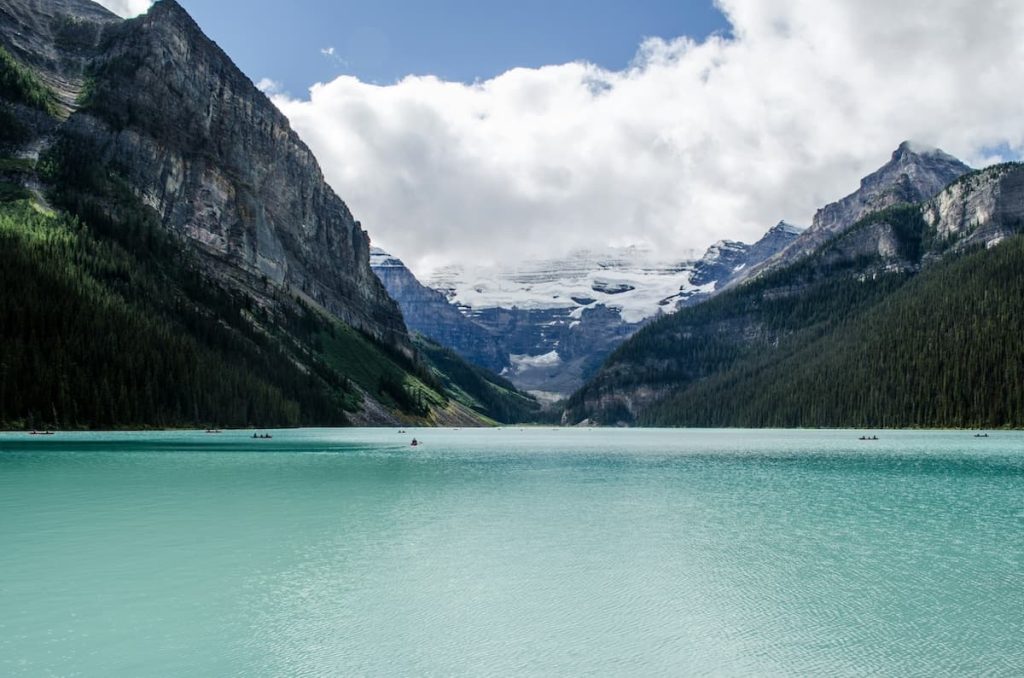 Blue waters at Lake Louise in Banff surrounded by mountains